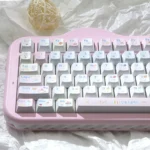Pink and blue pastel dessert keycaps on a keyboard, showing adorable hand-drawn dessert and character novelties in dye-sublimated Cherry profile PBT.