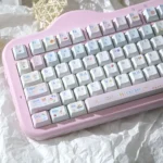 Pastel dessert keycaps in Cherry profile PBT with dye-sublimated cute sweets and character art on a pink keyboard for a playful desk.