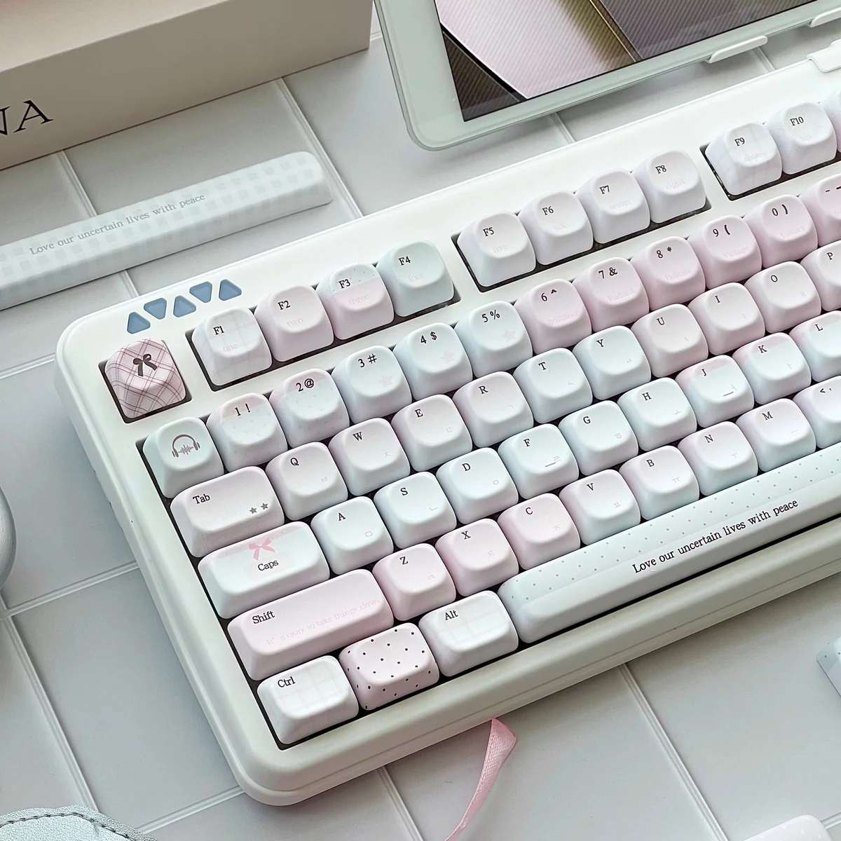 Pastel pink keycaps on a full PBT keycap set with gingham bow and heart accents, side-lit legends, and a romantic dreamy desk aesthetic.