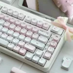 Pastel pink love letter keycaps with side-lit PBT legends, gingham accents, bows, and heart details create a dreamy romantic keyboard desk aesthetic.