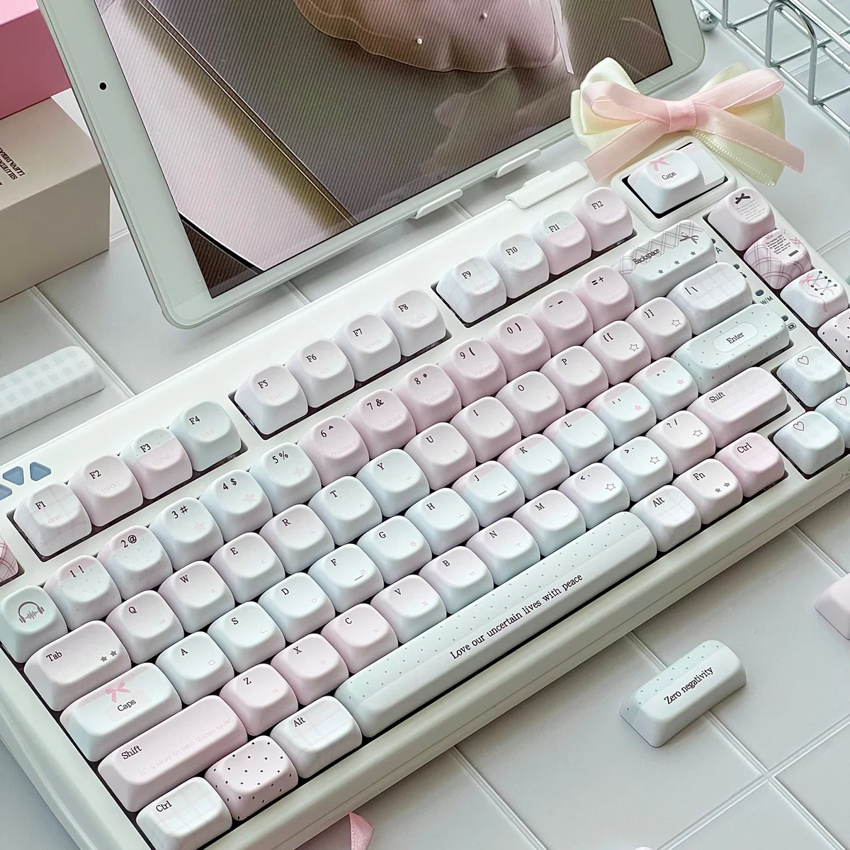 Pastel pink keycaps with gingham, bow, and heart details feature side-lit PBT and engraved legends for a dreamy romantic desk.