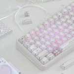 Pastel pink keycaps with side-lit PBT legends, gingham and heart details, styled with a sweet bow for a dreamy romantic desk.
