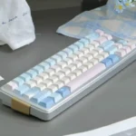 Poetic Tranquility minimalist PBT keycaps set, soft pastel blue and pink. Multiple angles showcase their serene, artistic design and premium PBT durability.