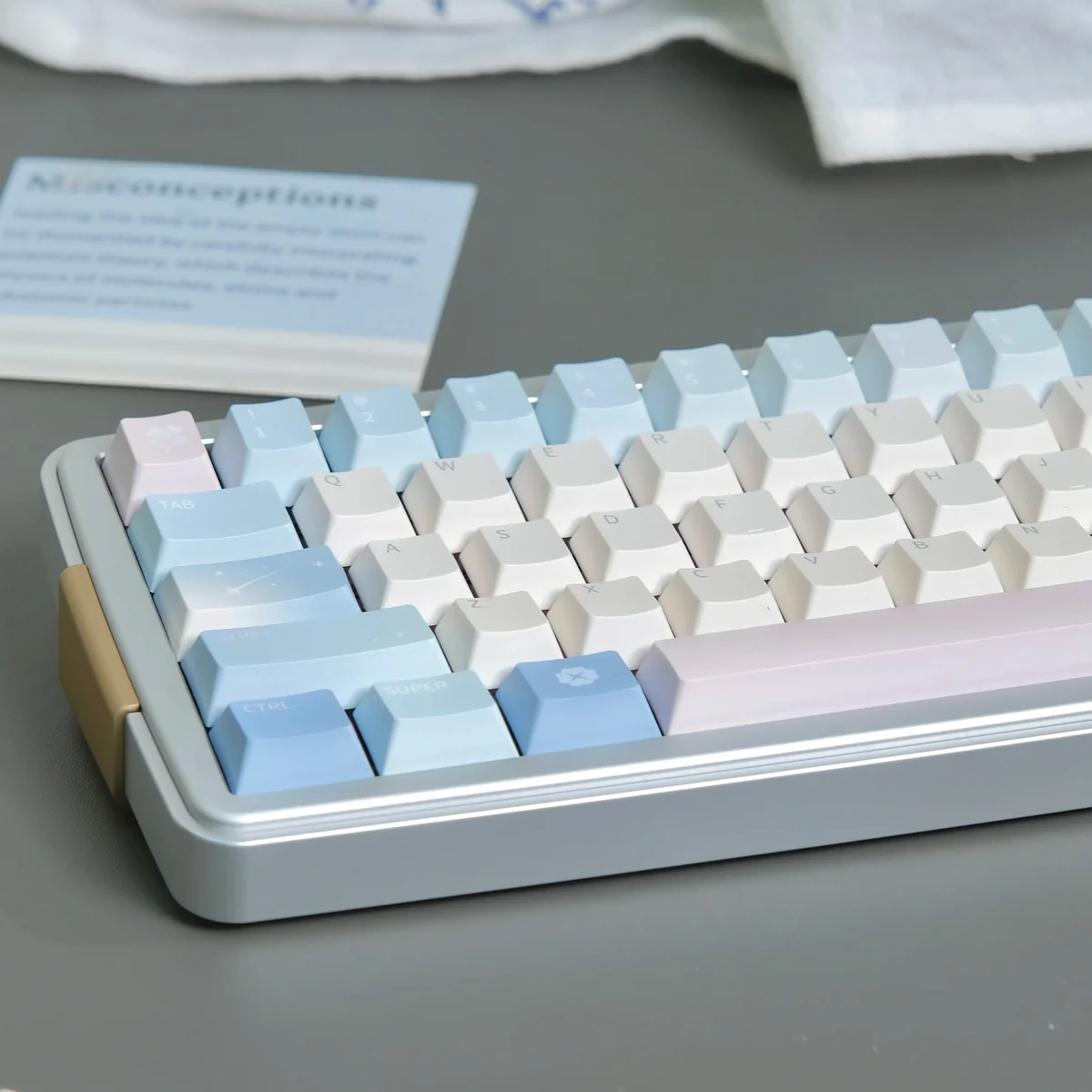 Poetic Tranquility PBT keycaps set in soft pastel blue and pink, captured at an artistic angle, showcasing their serene design and premium material.