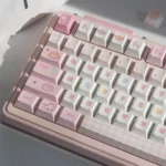 Product gallery of the 152-key Pooping Kitten Keycap Set, showcasing various charming cartoon feline designs and vibrant, whimsical keycap details.