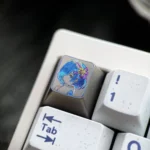 Artistic close-up of a hand-carved Re:Zero Rem titanium artisan keycap, showcasing vibrant colorful lines and premium craftsmanship on its surface.