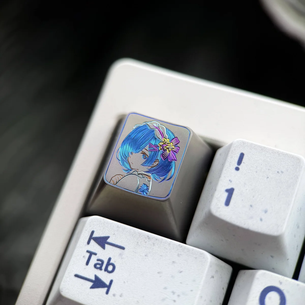 Artistic close-up of a hand-carved Re:Zero Rem titanium artisan keycap, showcasing vibrant colorful lines and premium craftsmanship on its surface.