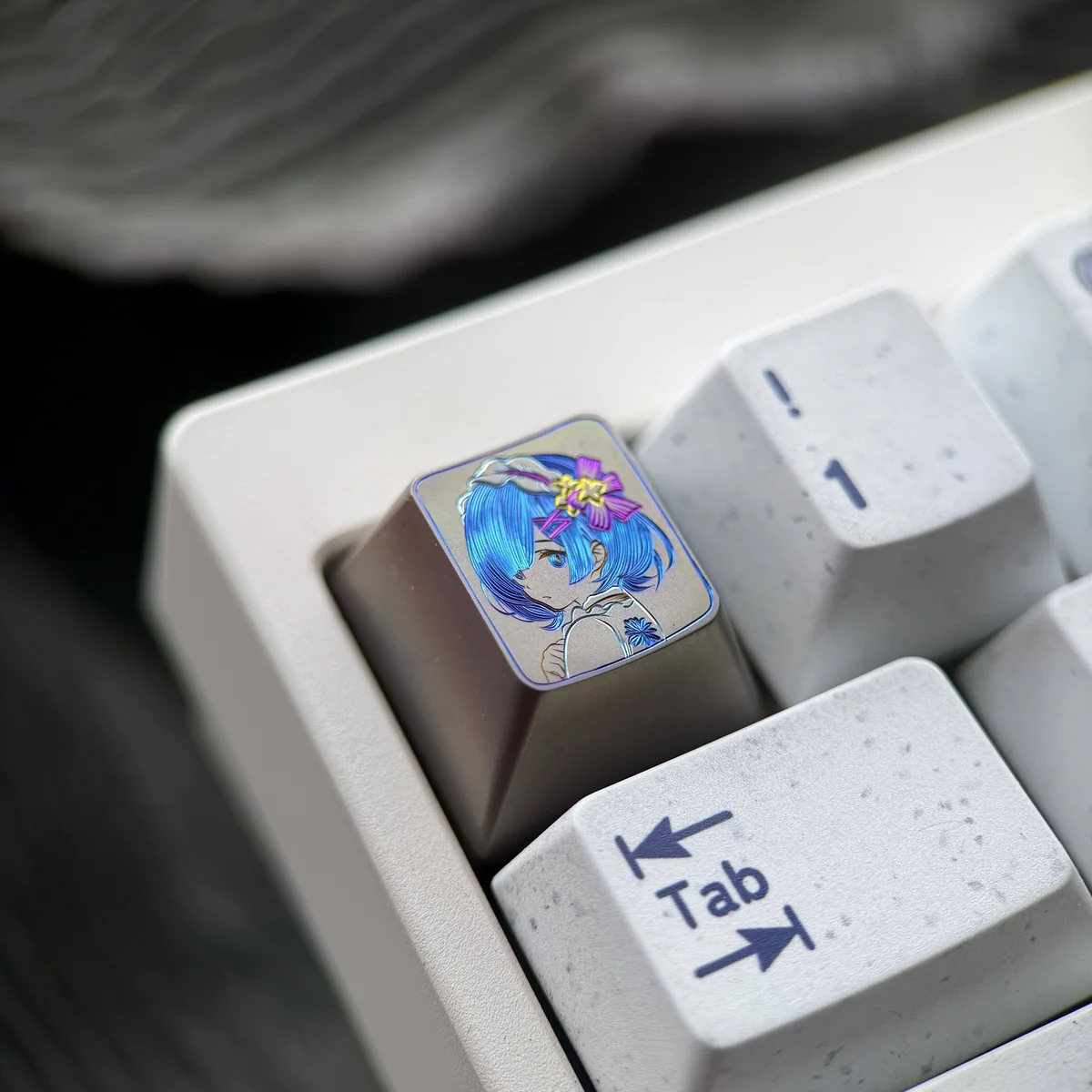 A detailed view of the vibrant hand-carved Re:Zero Rem artisan keycap, showcasing the intricate colorful lines on its premium titanium surface.