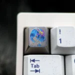 Vibrant hand-carved Re:Zero Rem titanium artisan keycap, showcasing colorful lines and exquisite detail on a premium surface.