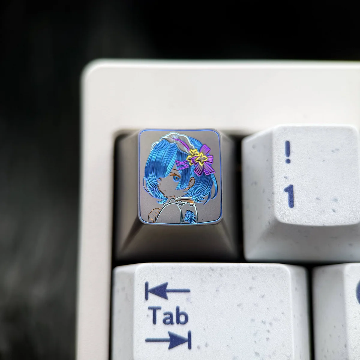 Vibrant hand-carved Re:Zero Rem titanium artisan keycap, showcasing colorful lines and exquisite detail on a premium surface.