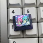 Rem Ram titanium keycap in deep blue-purple anodized titanium, featuring pastel pink and teal twin-maid anime artwork on a keyboard.