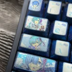 Violet-blue anodized Rem titanium keycap set with pastel anime maid portraits, floral accents, and Re:Zero lettering on a keyboard.
