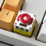 Detailed views of the interactive rotatable emergency keycap, showcasing its vibrant red industrial switch.