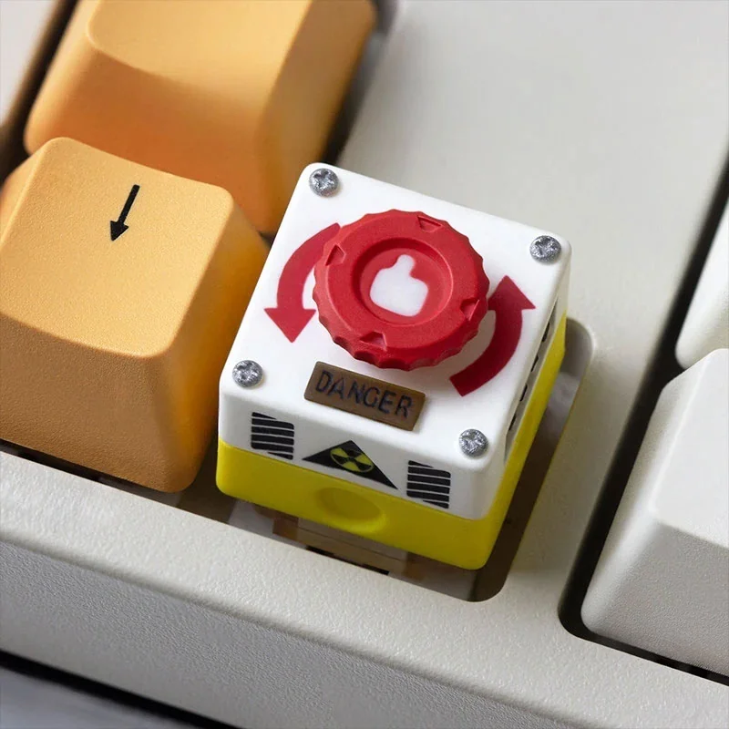 Detailed views of the interactive rotatable emergency keycap, showcasing its vibrant red industrial switch.