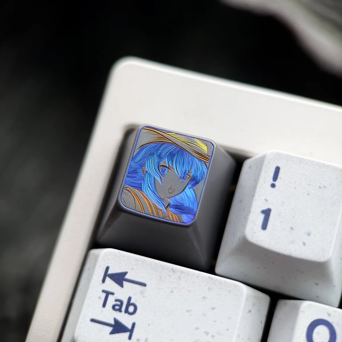Hand-carved Mushoku Tensei Roxy titanium keycap, featuring the intricate Roxy Loxolif design with vibrant colored lines, captured from a unique angle.