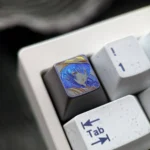 Detailed view of the artistic hand-carved Mushoku Tensei Roxy titanium keycap, revealing the intricate Roxy Loxolif design and its vibrant colored.
