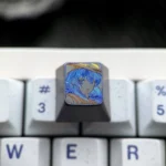 Hand-carved Mushoku Tensei Roxy titanium keycap, an intricate fan art piece, showcasing its vibrant colored lines and premium titanium texture.