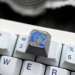 Intricate hand-carved Mushoku Tensei Roxy titanium keycap, showcasing its vibrant Roxy Loxolif design and premium craftsmanship from multiple angles.