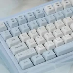 A collection of whimsical Cinnamoroll ceramic MX keycaps, showcasing various angles of their dreamy pastel design and smooth, tactile finish.