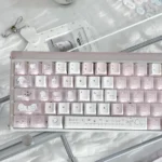 Sleepwalking pink and white PBT Cherry profile keycaps, displayed from playful angles. These dreamy pastel keycaps add a whimsical touch to any keyboard.