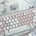 Playful gallery of Sleepwalking pink and white PBT Cherry profile keycaps, showcasing soft pastel glow from various angles for whimsical keyboards.