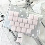 A dreamy 131-key Sleepwalking Pink Cherry PBT keycap set for keyboards, featuring soft pastel pink and white hues, perfect for a whimsical setup.