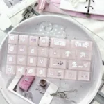 A playful close-up of 21 Sleepwalking pink and white heart-shaped PC keycaps, part of the dreamy Pink Cherry Keycap Set for mechanical keyboards.
