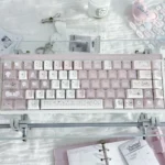 Sleepwalking pink and white PBT Cherry profile keycap set, glowing softly on a keyboard, creating a dreamy, whimsical aesthetic.