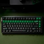 Source Code Keycaps, an artistic set with translucent PC and a striking Matrix-inspired green glow, perfect for a cyberpunk digital keyboard aesthetic.