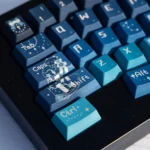 A close-up view of the Cosmic Journey Starry Keycap Set, showcasing the immersive deep blue and purple galaxy design with twinkling stars, perfect for fans.