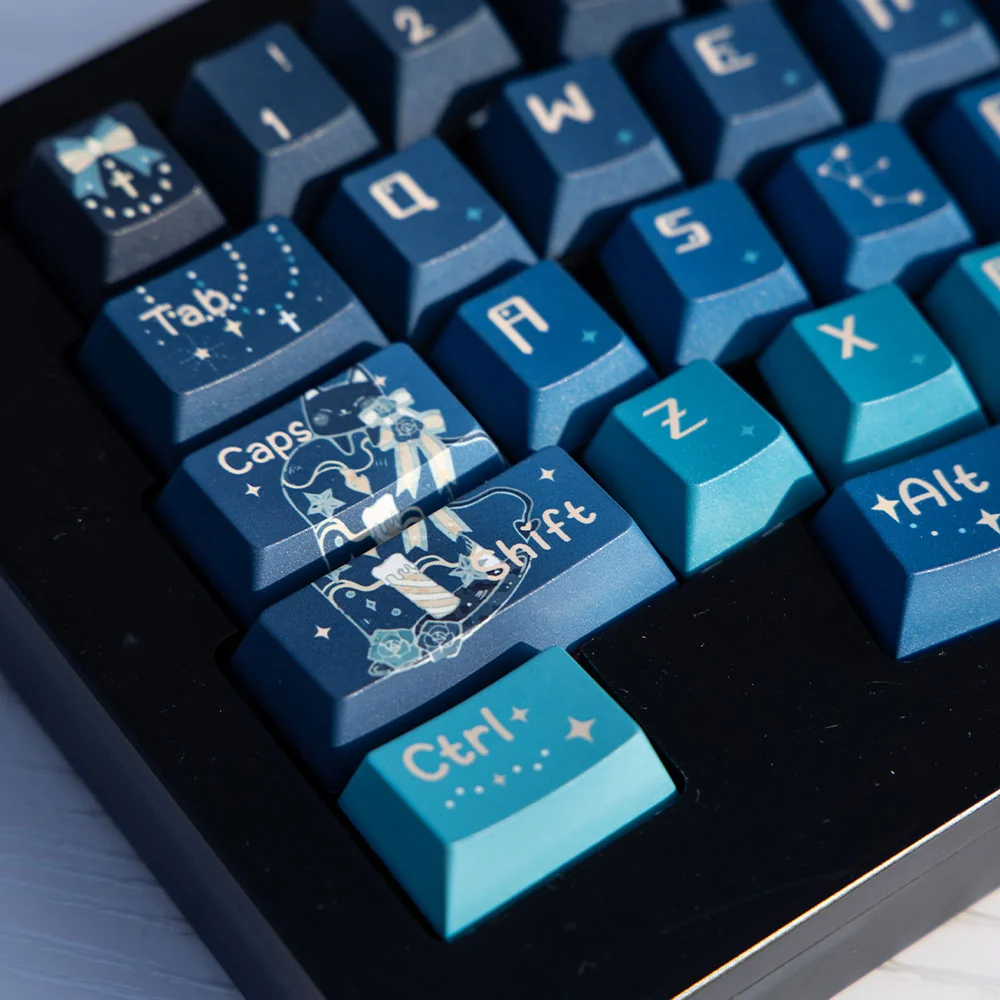 A close-up view of the Cosmic Journey Starry Keycap Set, showcasing the immersive deep blue and purple galaxy design with twinkling stars, perfect for fans.