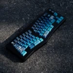 Immersive Cosmic Journey Starry Keycap Set featuring an artistic galaxy design in deep blue, purple, and blue-green hues, depicting nebulae and stars.