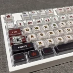A gallery view of Stranger Things Amber Pudding PBT keycaps, revealing their iconic translucent amber glow and playful retro 80s Hawkins aesthetic.