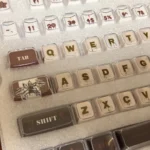 Explore multiple angles of Stranger Things Amber Pudding PBT keycaps, revealing their iconic translucent amber glow and retro 80s iconography.
