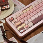 Angled view of pastel pink and chocolate brown Strawberry Chocolate keycaps with dessert and gingham motifs, dye-sublimated PBT MOA profile.
