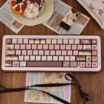 Strawberry Chocolate keycaps in pastel pink and brown feature dye-sublimated PBT MOA dessert art with strawberry cake and gingham motifs.