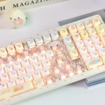 Close-up of adorable Sumikko Gurashi translucent MOA keycaps from various angles, highlighting their milky finish and whimsical characters for a playful typing.
