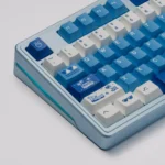 The Surfing Keycap Set, showcasing its vibrant blue and white ocean wave aesthetic for mechanical keyboards, is displayed from multiple angles.