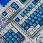Artistic Surfing Keycap Set displayed from multiple angles, highlighting its serene blue and white ocean waves aesthetic for custom mechanical keyboard.