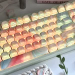 Angled close-up of the 134-key translucent MOA keycaps in Jade Dream, glowing with pastel marble swirls and soft backlit gradients.