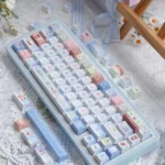 Detailed views of the Cozy Winter Bear PBT Dye-sub Keycap Set, showcasing playful bears and snowy scenes in muted tones from multiple angles.