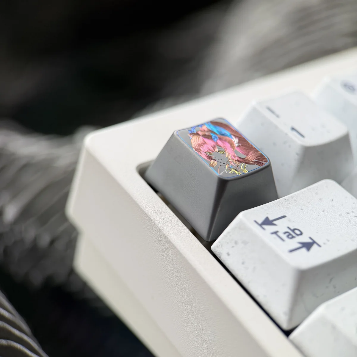 Close-up view of the Wuthering Waves Aemeath hand-carved titanium keycap, showcasing its intricate futuristic design and premium metal finish.