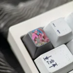 Close-up shots of the Wuthering Waves Aemeath hand-carved titanium keycap, revealing intricate futuristic details and its premium metallic finish.