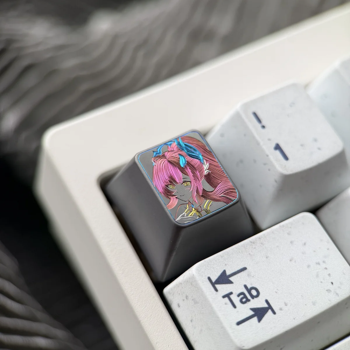 Close-up shots of the Wuthering Waves Aemeath hand-carved titanium keycap, revealing intricate futuristic details and its premium metallic finish.