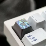 Hand-carved Wuthering Waves The Shorekeeper titanium keycap, showing intricate vibrant metallic details from a fresh angle.